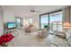 Cozy living room with recliner seating and balcony access with a view at 25188 Marion Ave # D308, Punta Gorda, FL 33950