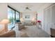 Comfortable living room with seating and a bright balcony with scenic views at 25188 Marion Ave # D308, Punta Gorda, FL 33950