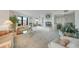 Spacious living room with plush sofas, fireplace, and large windows with a serene view at 25188 Marion Ave # D308, Punta Gorda, FL 33950
