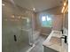 Modern bathroom featuring a glass-enclosed shower, soaking tub, and a dual sink vanity at 302 Albatross Rd, Rotonda West, FL 33947
