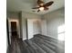 Clean bedroom featuring neutral walls, ceiling fan, closet, and wood-look flooring at 302 Albatross Rd, Rotonda West, FL 33947