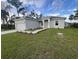 A charming single-story home featuring a well-manicured lawn and attached one car garage at 302 Albatross Rd, Rotonda West, FL 33947