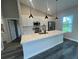 Modern kitchen with quartz countertops, stainless appliances, a herringbone backsplash, and stylish pendant lighting at 302 Albatross Rd, Rotonda West, FL 33947