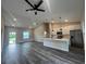 Open-concept living area boasts vaulted ceilings and a modern kitchen with quartz countertops and stainless appliances at 302 Albatross Rd, Rotonda West, FL 33947