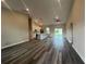 Bright living space with vaulted ceilings flowing into the modern kitchen and large windows at 302 Albatross Rd, Rotonda West, FL 33947