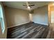 A spacious main bedroom with sleek, wood-look floors and a ceiling fan at 302 Albatross Rd, Rotonda West, FL 33947