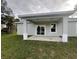 A covered outdoor patio, ideal for entertaining or relaxing in the backyard of this home at 302 Albatross Rd, Rotonda West, FL 33947
