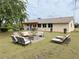 Backyard featuring an outdoor seating area and a pergola, perfect for relaxing and entertaining at 3415 Gulf Ln, Rotonda West, FL 33947