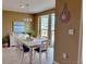Cozy dining room with view to the outside, neutral paint and a modern chandelier at 3415 Gulf Ln, Rotonda West, FL 33947