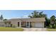 Charming single-story home with a well-manicured lawn and a convenient attached one car garage at 3415 Gulf Ln, Rotonda West, FL 33947