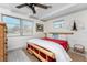 Relaxing bedroom with a bamboo bed frame, ceiling fan, and windows overlooking the yard at 350 W Cowles St, Englewood, FL 34223