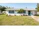 A charming single-story home boasts a well-maintained lawn and quaint curb appeal at 350 W Cowles St, Englewood, FL 34223