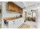 Functional kitchen with wood countertops, white cabinets, and adjacent dining area at 350 W Cowles St, Englewood, FL 34223