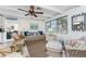 Cozy living room with wicker furniture, ceiling fan, and ample natural light at 350 W Cowles St, Englewood, FL 34223