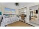 Cozy sun room with a daybed, shelves, and plenty of natural light through the windows at 350 W Cowles St, Englewood, FL 34223