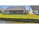A scenic view of the home's yard and pond at 410 Blue Springs Ct # 189, Englewood, FL 34223