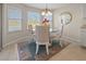 Cozy breakfast nook with a glass table, decorative rug, and bright natural light at 410 Blue Springs Ct # 189, Englewood, FL 34223
