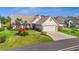 Charming home featuring a well-manicured lawn, vibrant landscaping, and a two-car garage at 410 Blue Springs Ct # 189, Englewood, FL 34223