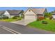 Well-maintained home with lush landscaping, a two-car garage, and a paved driveway at 410 Blue Springs Ct # 189, Englewood, FL 34223