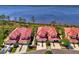 Aerial view of condos featuring red tile roofs and well maintained landscaping near the water at 4692 Club Dr # 101, Port Charlotte, FL 33953