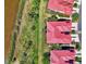 An aerial view of condos with red tile roofs near a waterfront with lush landscaping and parking spaces at 4692 Club Dr # 101, Port Charlotte, FL 33953