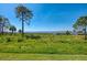 Backyard showcasing stunning water views and lush green space for outdoor enjoyment at 4692 Club Dr # 101, Port Charlotte, FL 33953