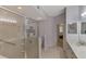 Bright bathroom features a glass shower, tiled floors, and modern vanity with plenty of light at 4692 Club Dr # 101, Port Charlotte, FL 33953