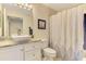 Clean, bright bathroom with a white vanity, vessel sink, and shower with patterned curtain at 4692 Club Dr # 101, Port Charlotte, FL 33953