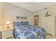 Relaxing bedroom features a white ceiling fan and tasteful coastal decor and furniture at 4692 Club Dr # 101, Port Charlotte, FL 33953