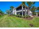 Exterior of home featuring large screened balcony and lush landscaping in a desirable location at 4692 Club Dr # 101, Port Charlotte, FL 33953