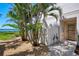 Exterior view of property entrance featuring tropical landscaping, gravel and charming decorative heron statues at 4692 Club Dr # 101, Port Charlotte, FL 33953