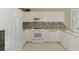 Modern kitchen featuring white cabinets, granite countertops, and stainless steel appliances at 4692 Club Dr # 101, Port Charlotte, FL 33953