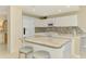 Bright kitchen features white cabinets, granite countertops, and stainless steel appliances at 4692 Club Dr # 101, Port Charlotte, FL 33953