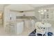 Bright kitchen featuring white cabinetry, granite countertops, stainless appliances, and dining area at 4692 Club Dr # 101, Port Charlotte, FL 33953