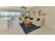Living room with waterfront views, tiled floors, ceiling fan and access to patio seating at 4692 Club Dr # 101, Port Charlotte, FL 33953