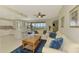 Combined living and dining area with waterfront view, tile floors, ceiling fan, and an open kitchen concept at 4692 Club Dr # 101, Port Charlotte, FL 33953