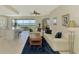 Open-concept living area with large windows offering beautiful water views, tiled floors, and comfortable seating at 4692 Club Dr # 101, Port Charlotte, FL 33953