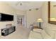 Comfortable living room with a TV, a loveseat, a chair and an adjacent open door at 4692 Club Dr # 101, Port Charlotte, FL 33953
