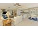 Open-concept living area with neutral decor, tile flooring, and views into the kitchen and dining space at 4692 Club Dr # 101, Port Charlotte, FL 33953