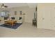 Comfortable living room with neutral tones, tile floors, and access to other areas of the home at 4692 Club Dr # 101, Port Charlotte, FL 33953