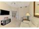 Comfortable living room with a TV, a loveseat, a chair and an adjacent open door at 4692 Club Dr # 101, Port Charlotte, FL 33953