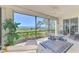 Screened patio features comfortable furniture, a fan, and views of the water at 4692 Club Dr # 101, Port Charlotte, FL 33953