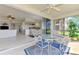 Bright patio featuring a glass table and views of the water and the open concept interior at 4692 Club Dr # 101, Port Charlotte, FL 33953