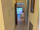 Hallway leading to a bedroom with a view of a screened porch at 5 Quails Run Blvd # 9, Englewood, FL 34223