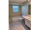 Bathroom featuring retro-style tile, bathtub, and sink at 5234 Forbes Ter, Port Charlotte, FL 33981