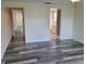 Bright bedroom featuring doorway views to the hallway and a bathroom with gray-toned vinyl plank flooring at 5234 Forbes Ter, Port Charlotte, FL 33981