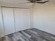 Bedroom with closet, modern gray wood flooring, and ceiling fan at 5234 Forbes Ter, Port Charlotte, FL 33981