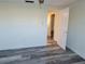 Neutral bedroom featuring modern gray wood flooring and an open door at 5234 Forbes Ter, Port Charlotte, FL 33981