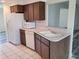 The kitchen features white appliances, wood cabinets, and an open view to the living room at 5234 Forbes Ter, Port Charlotte, FL 33981