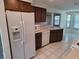 Bright kitchen features white appliances, wood cabinets, and tile flooring at 5234 Forbes Ter, Port Charlotte, FL 33981